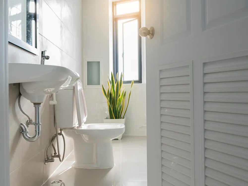 A clean bathroom with a freshly installed toilet and sink