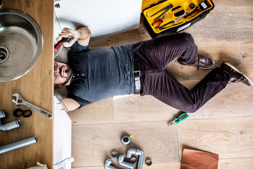 man fixing kitchen sink