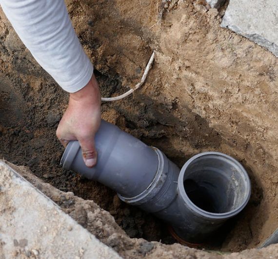 a plumber installing a pipe